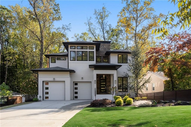 view of front of home featuring a garage and a front lawn