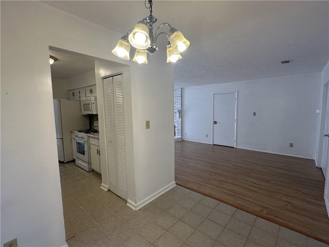 interior space featuring an inviting chandelier and light wood-type flooring