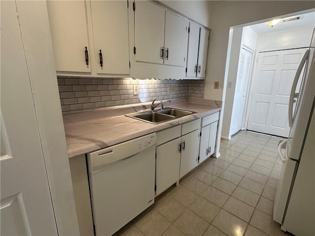 kitchen with white appliances, white cabinetry, sink, and tasteful backsplash