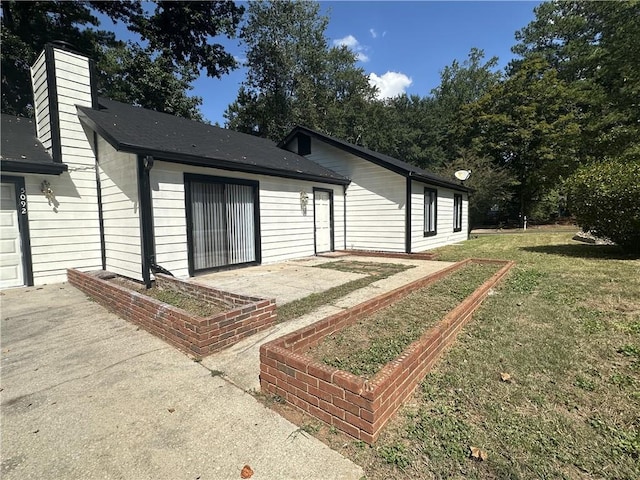 exterior space featuring a yard and a patio area