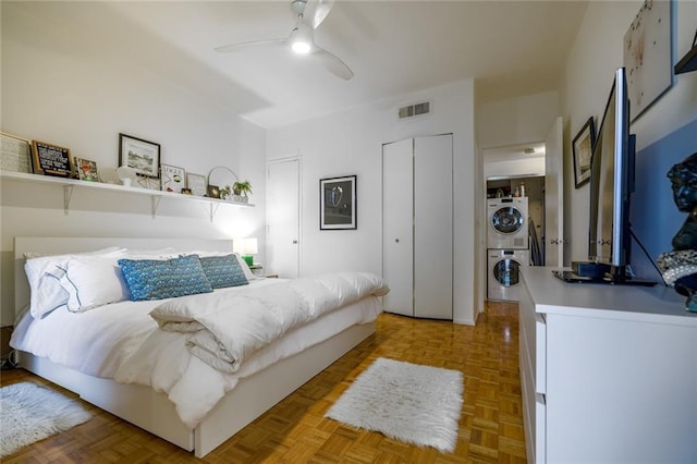 130 26th St NW Unit 701, Atlanta, GA 30309 - bedroom with stacked washer / dryer, a closet, and a ceiling fan