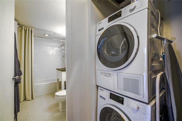 130 26th St NW Unit 701, Atlanta, GA 30309 - laundry room featuring stacked washer / dryer and tile patterned flooring
