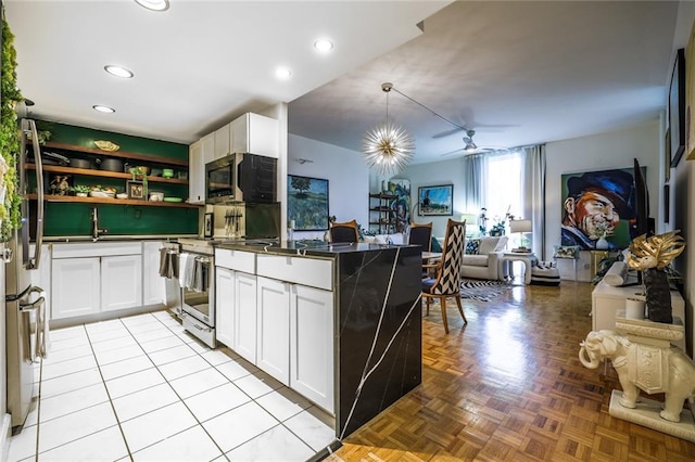 130 26th St NW Unit 701, Atlanta, GA 30309 - kitchen featuring open floor plan, a peninsula, ceiling fan, white cabinets, and recessed lighting