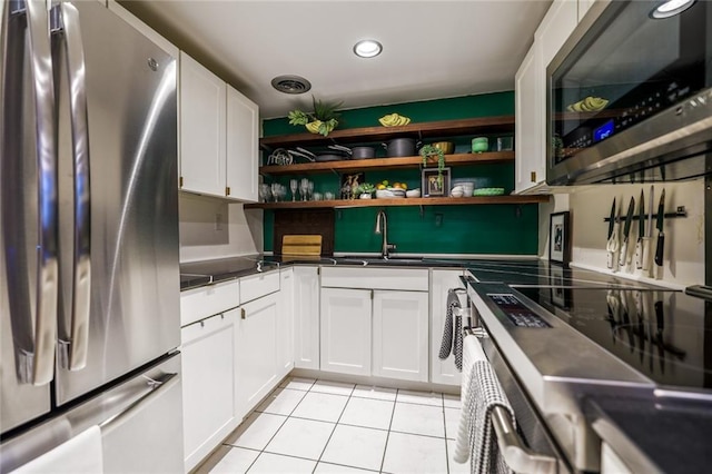 130 26th St NW Unit 701, Atlanta, GA 30309 - kitchen featuring appliances with stainless steel finishes, open shelves, a sink, dark countertops, and light tile patterned flooring