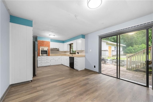 3664 Pin Oak Cir, Atlanta, GA 30340 - kitchen featuring dishwasher, oven, light countertops, wood finished floors, and baseboards