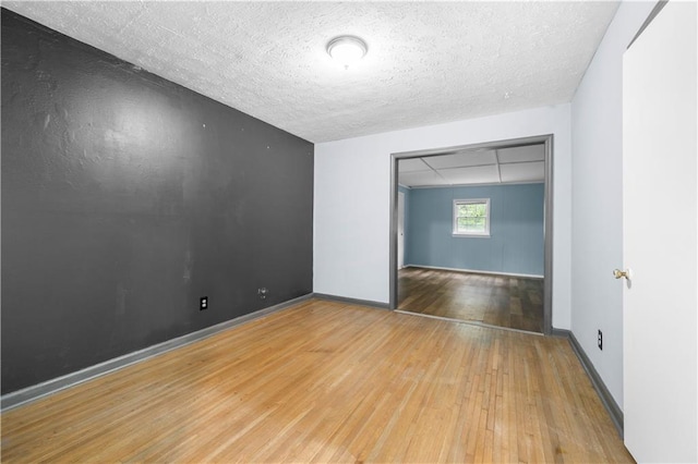 3664 Pin Oak Cir, Atlanta, GA 30340 - unfurnished room featuring hardwood / wood-style flooring, a textured ceiling, and baseboards