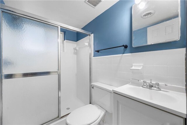 3664 Pin Oak Cir, Atlanta, GA 30340 - bathroom with toilet, vanity, tile walls, and a stall shower