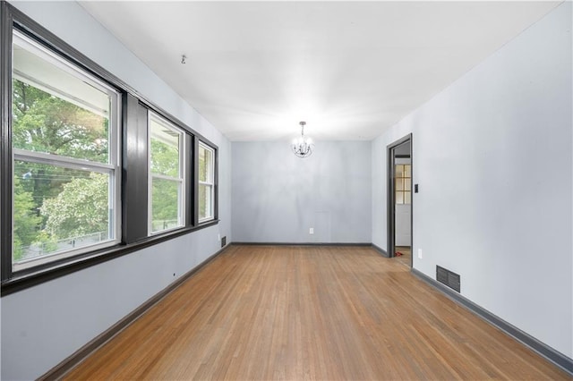 3664 Pin Oak Cir, Atlanta, GA 30340 - unfurnished room featuring light wood-type flooring, a chandelier, plenty of natural light, and baseboards