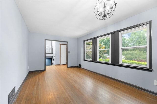 3664 Pin Oak Cir, Atlanta, GA 30340 - unfurnished room with a chandelier, wood finished floors, and baseboards