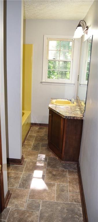 157 Sequoyah Cir, Canton, GA 30115 - full bath featuring vanity, stone tile flooring, a tub to relax in, a textured ceiling, and baseboards