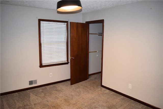 157 Sequoyah Cir, Canton, GA 30115 - unfurnished bedroom featuring carpet flooring, a textured ceiling, baseboards, a closet, and a spacious closet