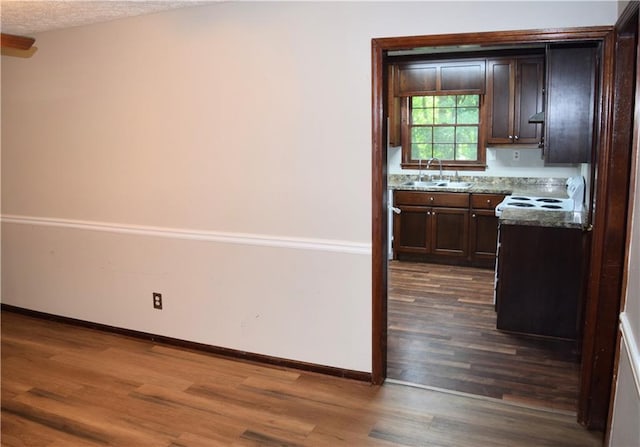 157 Sequoyah Cir, Canton, GA 30115 - kitchen featuring dark wood finished floors, a sink, baseboards, and dark brown cabinets