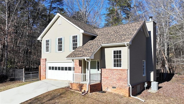 view of front facade featuring a garage and cooling unit