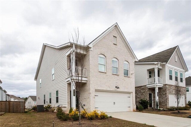 3739 Silvery Way, Powder Springs, GA 30127 - view of front of home featuring concrete driveway, a balcony, an attached garage, and brick siding