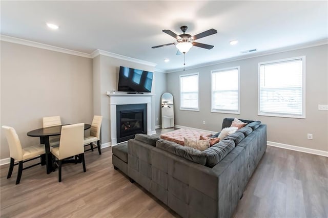 3739 Silvery Way, Powder Springs, GA 30127 - living room with a ceiling fan, visible vents, baseboards, light wood-style flooring, and ornamental molding
