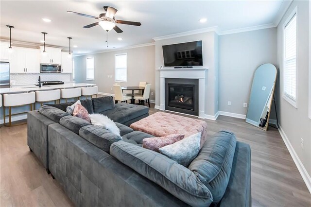 3739 Silvery Way, Powder Springs, GA 30127 - living area featuring ceiling fan, baseboards, ornamental molding, and light wood finished floors