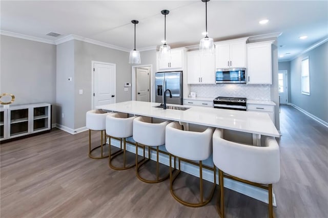 3739 Silvery Way, Powder Springs, GA 30127 - kitchen with a kitchen island with sink, backsplash, white cabinets, stainless steel appliances, and a sink