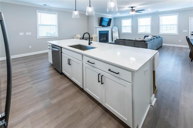 3739 Silvery Way, Powder Springs, GA 30127 - kitchen with a sink, ornamental molding, a fireplace, a ceiling fan, and stainless steel dishwasher