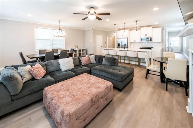 3739 Silvery Way, Powder Springs, GA 30127 - living room with light wood-style flooring, recessed lighting, ceiling fan with notable chandelier, and ornamental molding