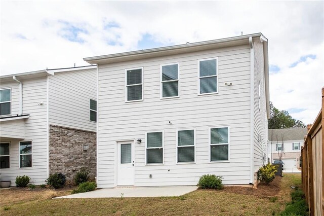 3739 Silvery Way, Powder Springs, GA 30127 - rear view of house with central air condition unit, a patio, a lawn, and brick siding