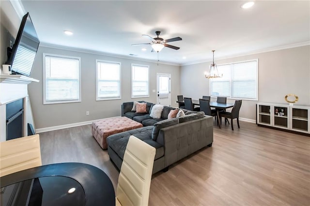3739 Silvery Way, Powder Springs, GA 30127 - living room with light wood finished floors, ceiling fan with notable chandelier, baseboards, and ornamental molding
