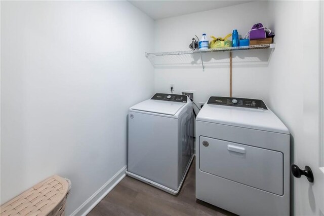 3739 Silvery Way, Powder Springs, GA 30127 - laundry room featuring washing machine and clothes dryer, laundry area, baseboards, and wood finished floors