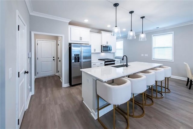 3739 Silvery Way, Powder Springs, GA 30127 - kitchen with a breakfast bar, ornamental molding, stainless steel appliances, and a sink