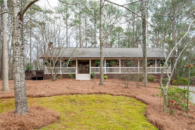 ranch-style home featuring a chimney