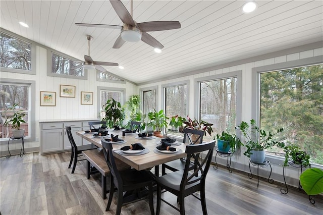 sunroom / solarium with wood ceiling, a healthy amount of sunlight, and vaulted ceiling