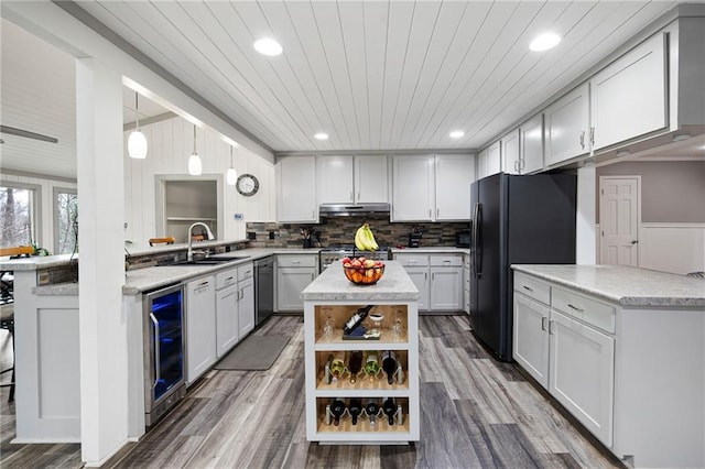 kitchen with beverage cooler, dishwasher, freestanding refrigerator, open shelves, and a sink