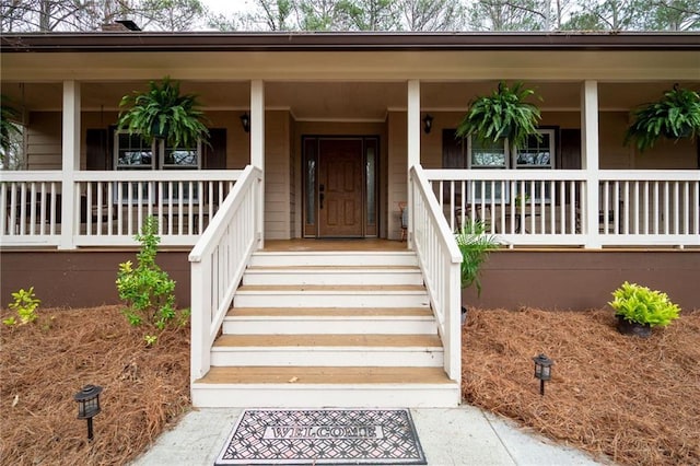 view of exterior entry with covered porch