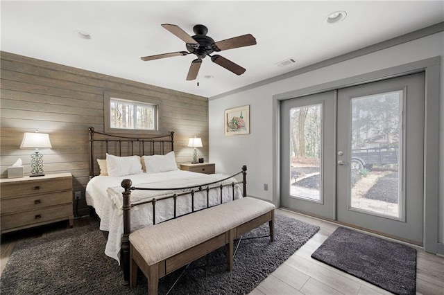 bedroom featuring french doors, recessed lighting, visible vents, wood finished floors, and access to outside