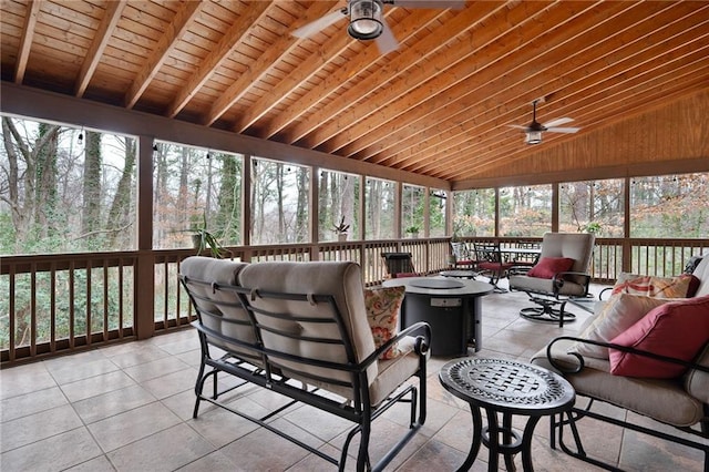 sunroom / solarium with lofted ceiling, ceiling fan, and wood ceiling