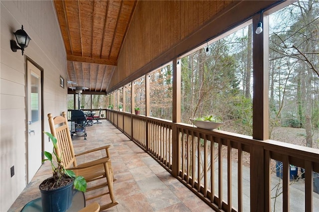 sunroom with vaulted ceiling and wood ceiling