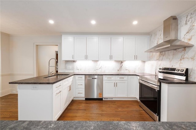 6141 Windsong Way, Smoke Rise, GA 30087 - kitchen featuring appliances with stainless steel finishes, exhaust hood, a sink, a peninsula, and white cabinets
