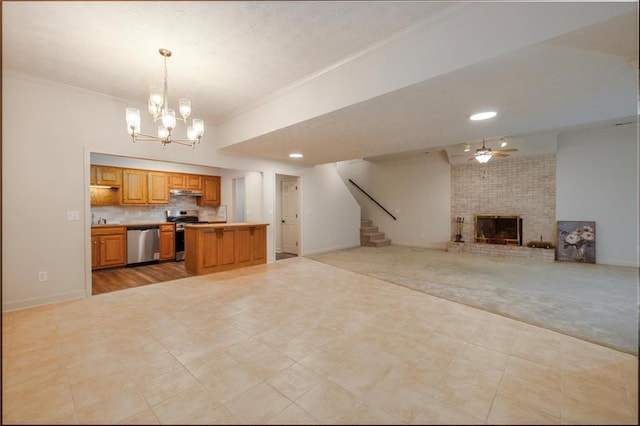 6141 Windsong Way, Smoke Rise, GA 30087 - kitchen with stainless steel appliances, open floor plan, a brick fireplace, a chandelier, and crown molding