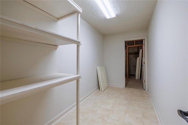 6141 Windsong Way, Smoke Rise, GA 30087 - corridor featuring baseboards and a textured ceiling