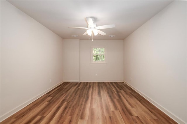 6141 Windsong Way, Smoke Rise, GA 30087 - empty room with wood finished floors, baseboards, and a ceiling fan