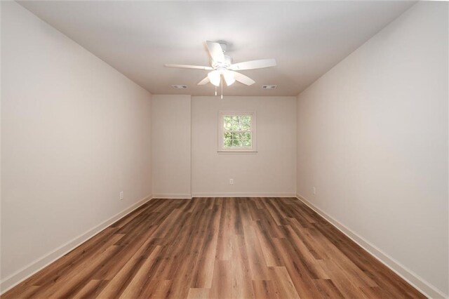 6141 Windsong Way, Smoke Rise, GA 30087 - empty room with wood finished floors, baseboards, and a ceiling fan
