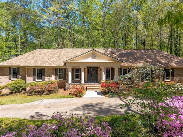 6141 Windsong Way, Smoke Rise, GA 30087 - neoclassical home featuring a porch and brick siding
