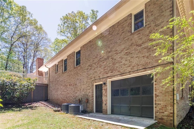 6141 Windsong Way, Smoke Rise, GA 30087 - view of property exterior with central AC and brick siding