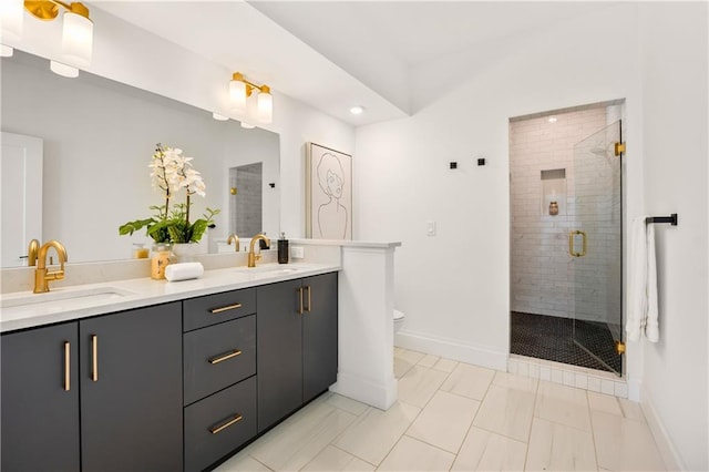 bathroom with a stall shower, a sink, toilet, and double vanity