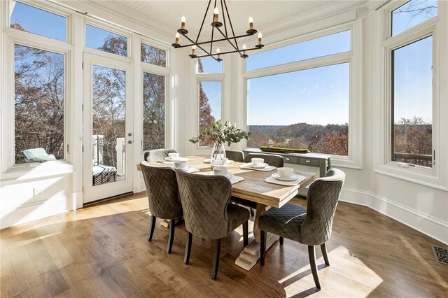 sunroom with a wealth of natural light and an inviting chandelier