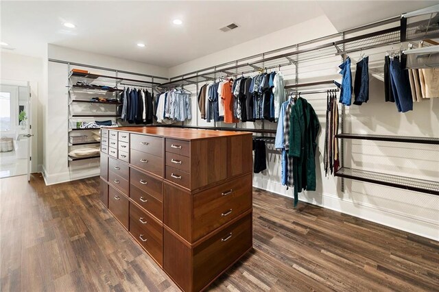 laundry room with visible vents, wood finished floors, separate washer and dryer, baseboards, and laundry area