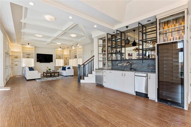 bar featuring a tray ceiling, visible vents, dark wood-style flooring, and dishwasher