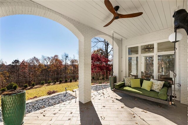 back of house with a lawn, fence, a balcony, a chimney, and a patio area