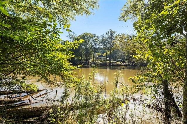 aerial view featuring a water view and a wooded view