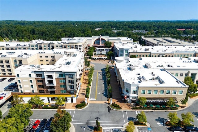 birds eye view of property featuring a wooded view