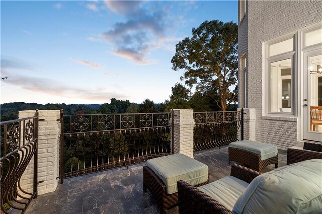 back of property at dusk with fence, stairs, a lawn, a chimney, and a patio