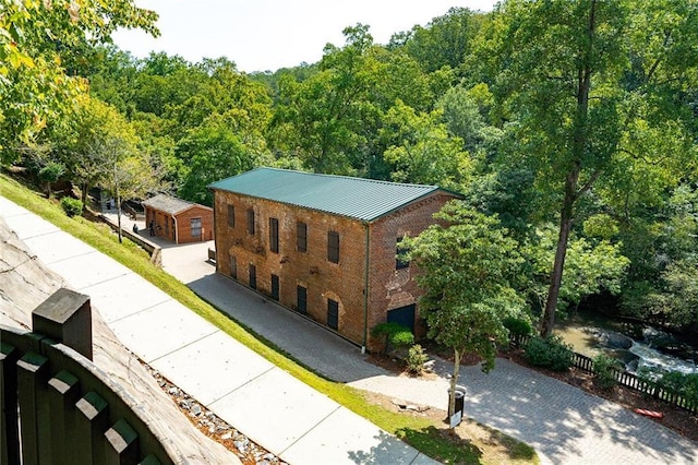 drone / aerial view with a wooded view